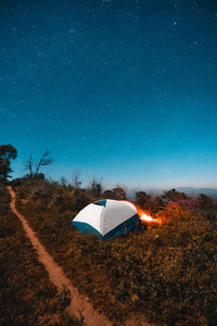 Tent on field against sky at night