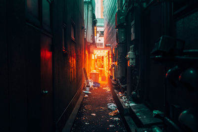 Street amidst buildings in city at night