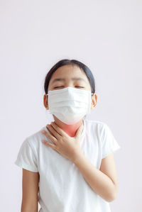 Portrait of girl standing against white background