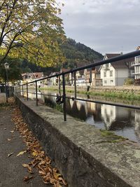 Bridge over river against sky during autumn