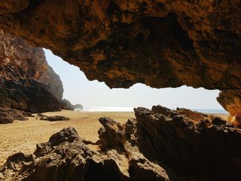 Scenic view of sea seen through cave