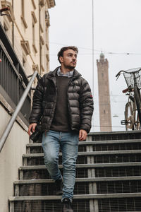 Young man moving down on steps