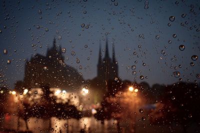 Raindrops on glass window at night