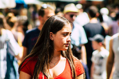 Portrait of young woman looking away outdoors