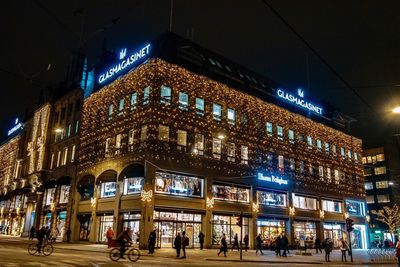 Group of people in illuminated building at night