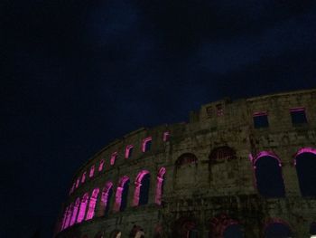 Low angle view of castle against sky at night