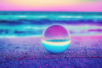 Close-up of crystal ball at beach