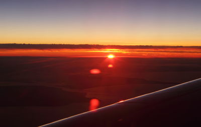 Scenic view of sunset seen through airplane window