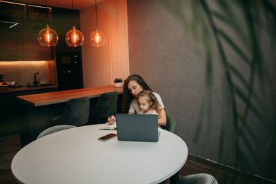 Mom works at home with her daughter