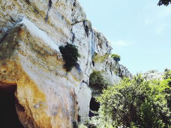 Low angle view of rock formation against sky