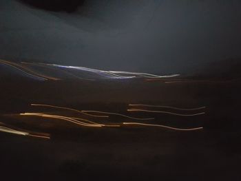 Close-up of light trails against sky at night