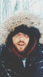 Portrait of smiling man in snow