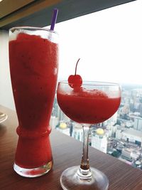 Close-up of red drink with ice cream