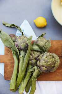 Fresh artichokes on cutting board