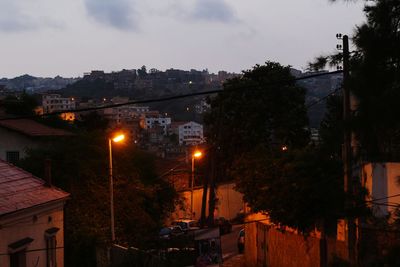 Illuminated buildings against sky at night