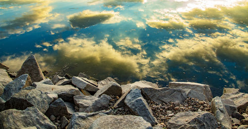 Rocks by sea against sky