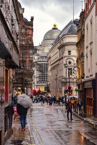 People on city street during rainy season