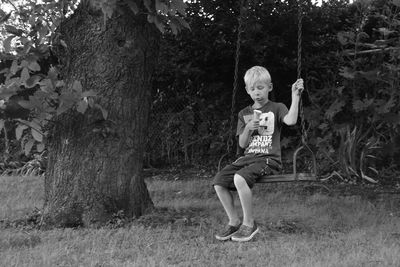 Full length of a boy on swing