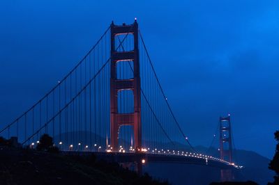 Suspension bridge in city at night
