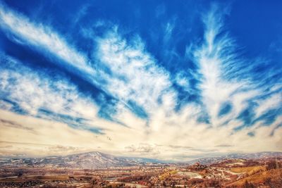 Aerial view of landscape against blue sky