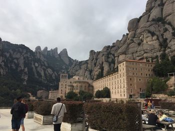 People on mountain against sky