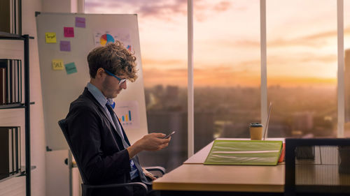 Side view of a man looking at table