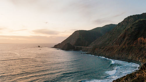 Scenic view of sea with mountain range in background