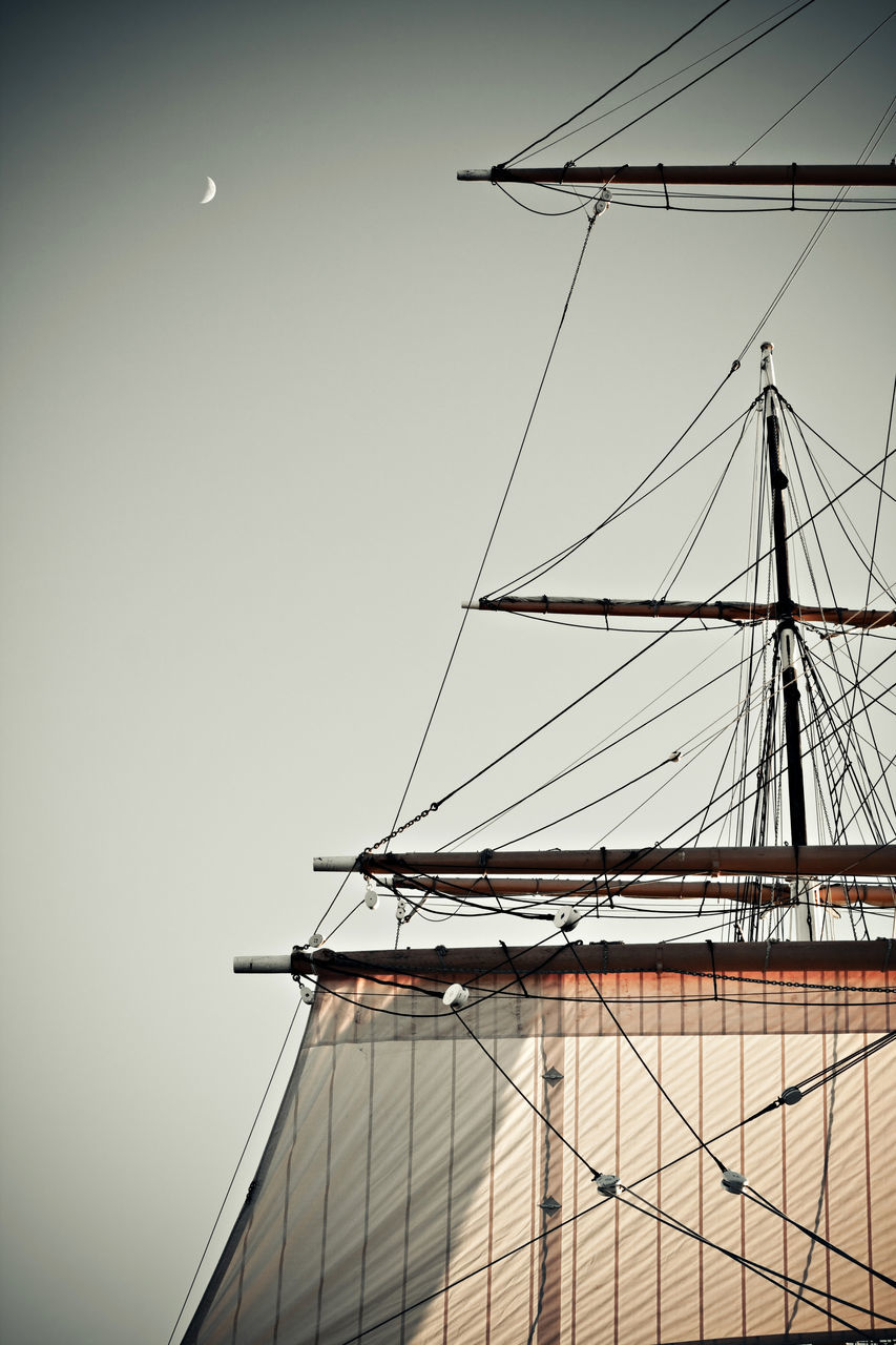 LOW ANGLE VIEW OF SAILBOAT AGAINST BUILDING