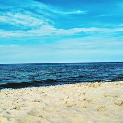 Scenic view of sea against blue sky