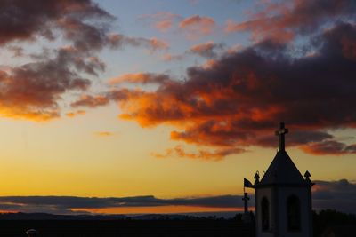 Silhouette building against sky during sunset