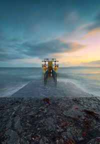 Beautiful seascape sunset scenery of blackrock diving tower at salthill beach in galway, ireland