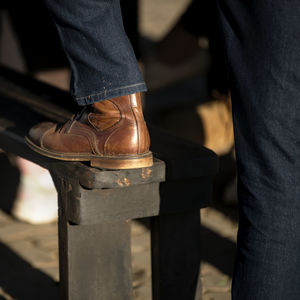 Low section of man standing on metal