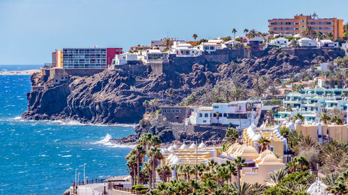 Panoramic shot of cityscape by sea against clear sky