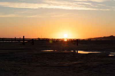 Scenic view of sea against orange sky