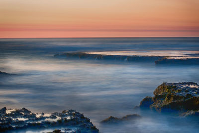 Scenic view of sea against sky during sunset