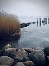 Scenic view of lake against sky during winter