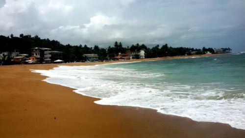 Scenic view of sea against cloudy sky