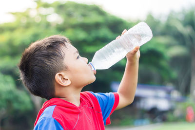 Portrait of boy drinking water from bottle