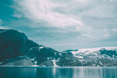 Scenic view of sea and mountains against sky