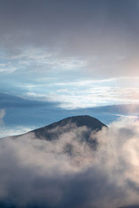 Low angle view of mountain against cloudy sky