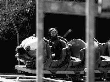 Full length of man sitting at amusement park