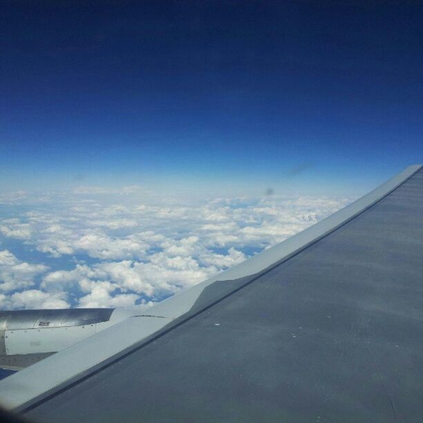 transportation, blue, sky, airplane, mode of transport, air vehicle, scenics, copy space, beauty in nature, cloud - sky, flying, cloud, part of, nature, cropped, aircraft wing, tranquil scene, tranquility, aerial view, travel