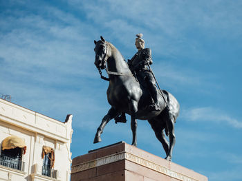 Low angle view of statue against sky