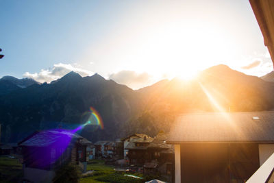 Panoramic view of illuminated mountains against sky during sunset