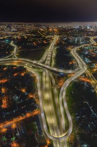 High angle view of illuminated city buildings at night