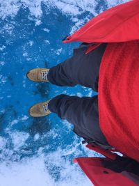 Low section of man standing on ice