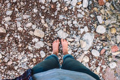 Low section of person standing on rock