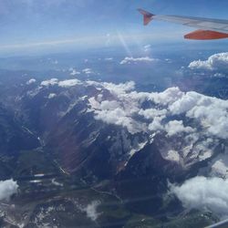 Cropped image of airplane flying over landscape