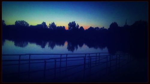 Scenic view of calm lake at sunset