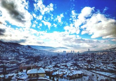 High angle view of town against cloudy sky